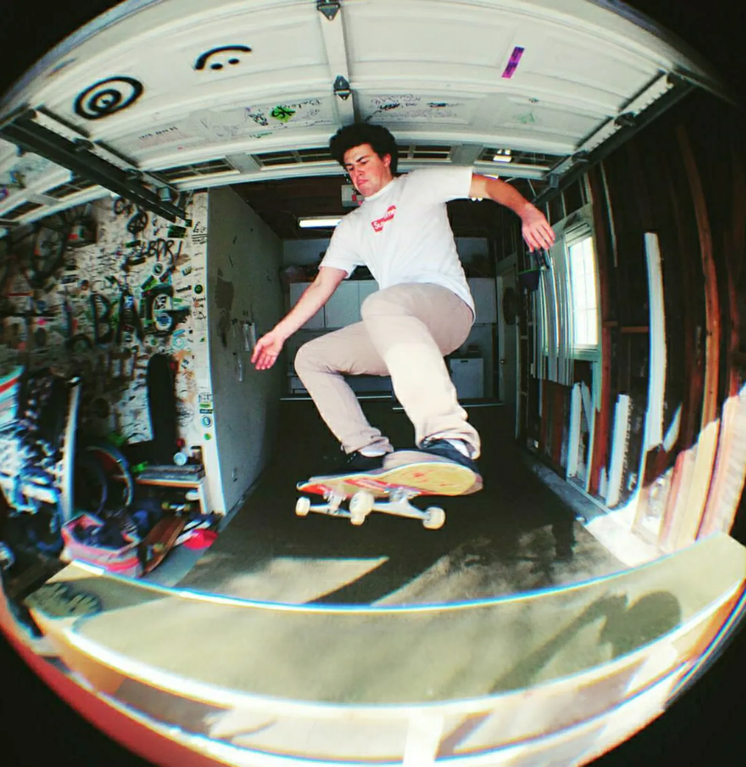 Two foot high miniramp in a garage with a man catching air