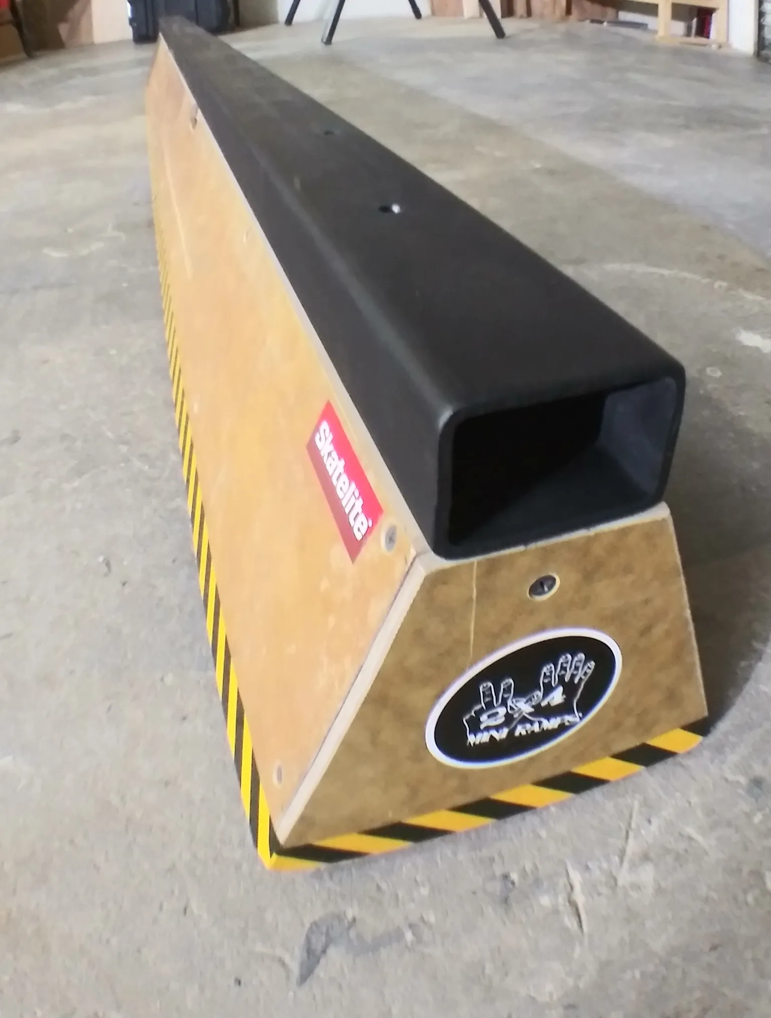 Eight foot long slappy flat bar sitting on concrete, front view